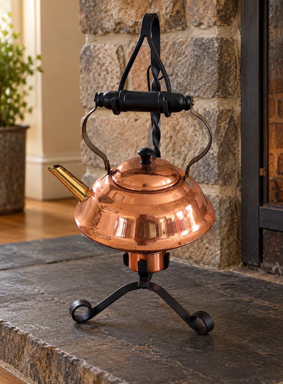 Copper kettle with fuel cup fitted beneath it in the iron stand