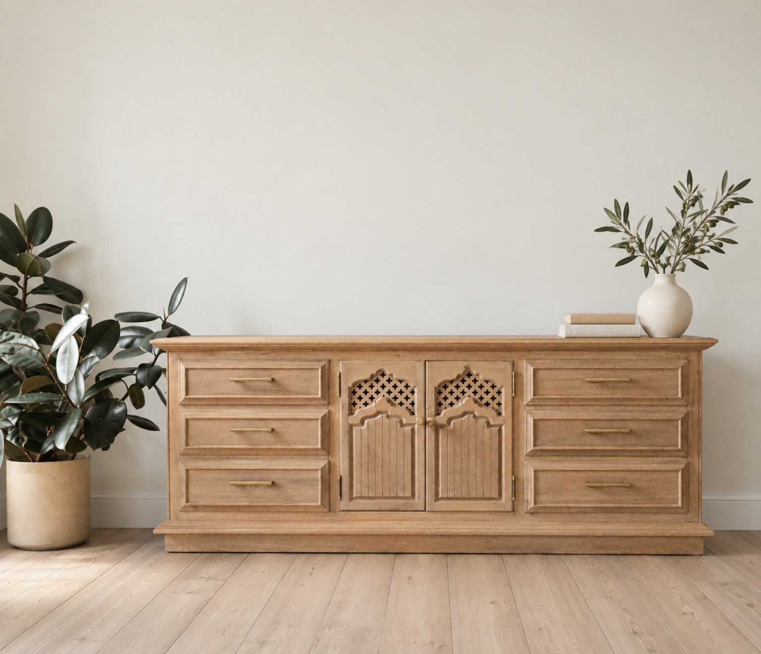Front view of a light wood vintage dresser with decorative center doors and brass-tone pulls