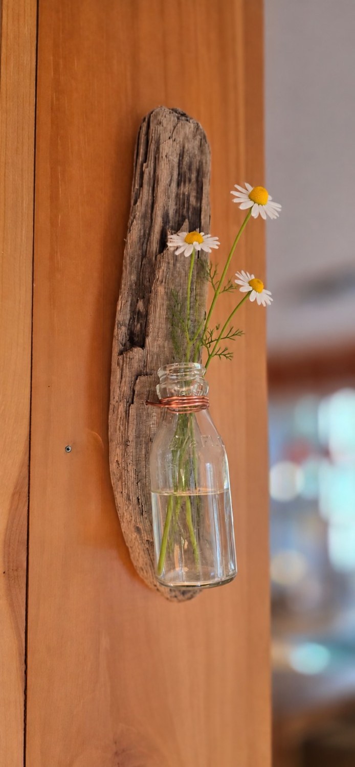 Rounded Bottle Wall Vase styled with white flowers